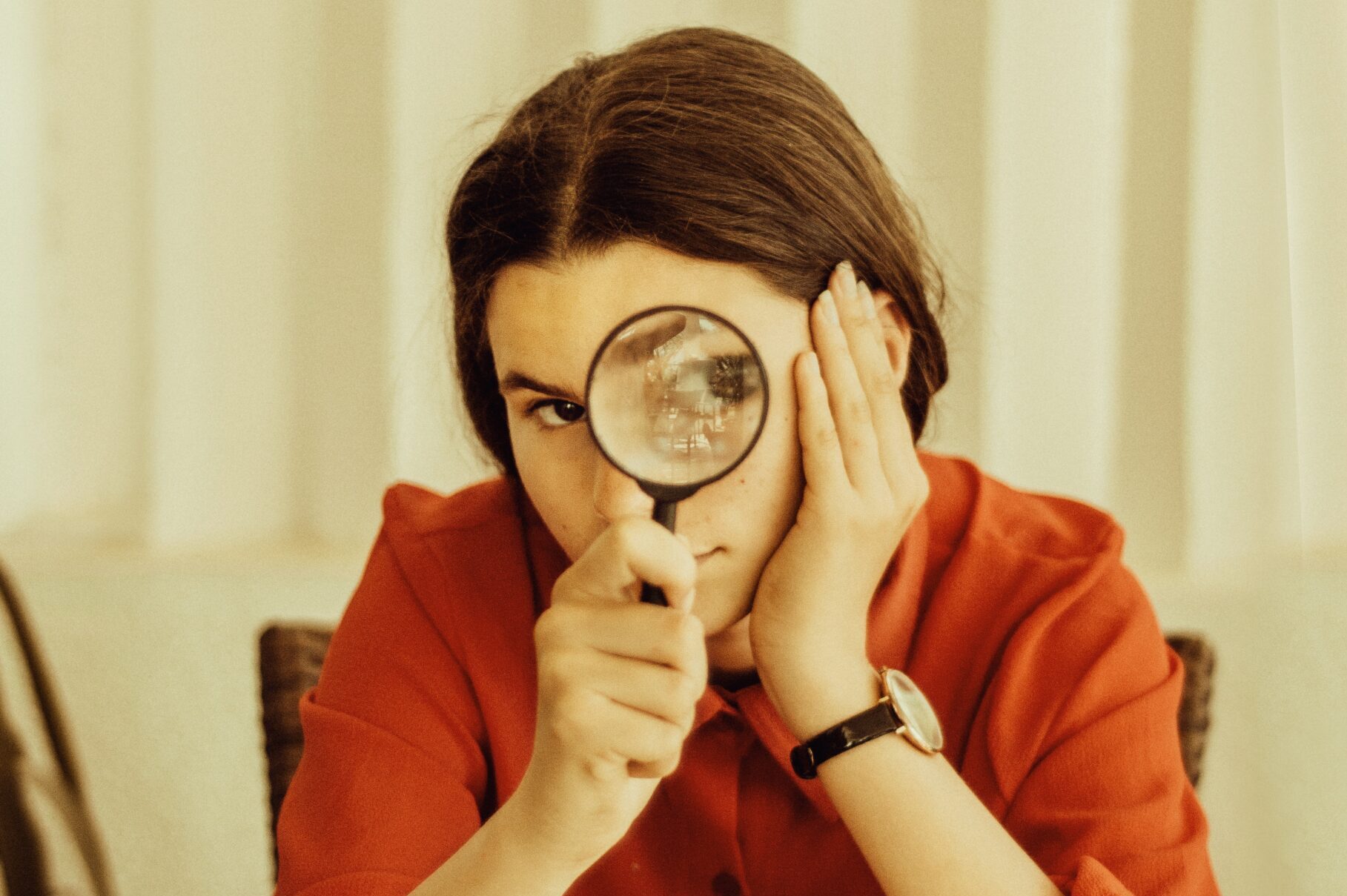 woman holding magnifying glass