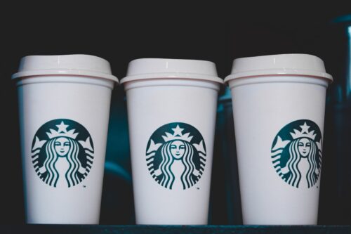 two white starbucks disposable cups
