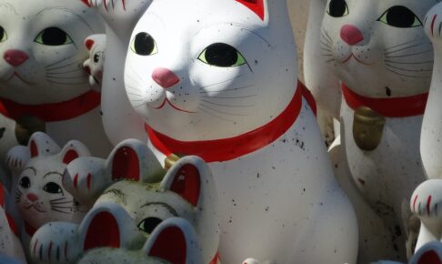white red and yellow ceramic cat figurines