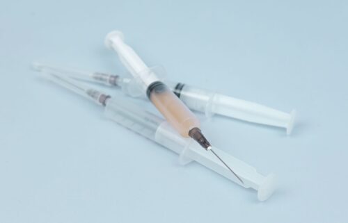 white and clear plastic syringe