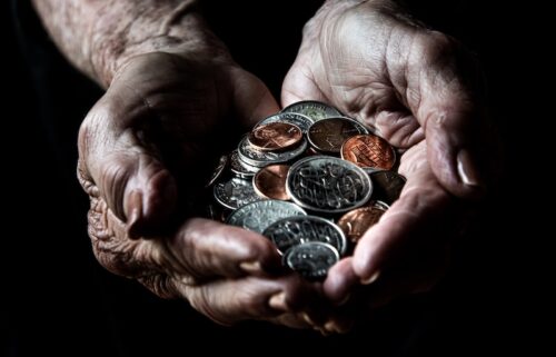 person holding silver round coins