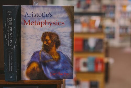 selective focus photography of Aristotle's Metaphysics book