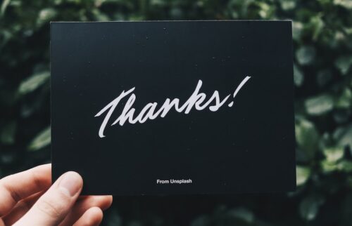 person holding Thanks card