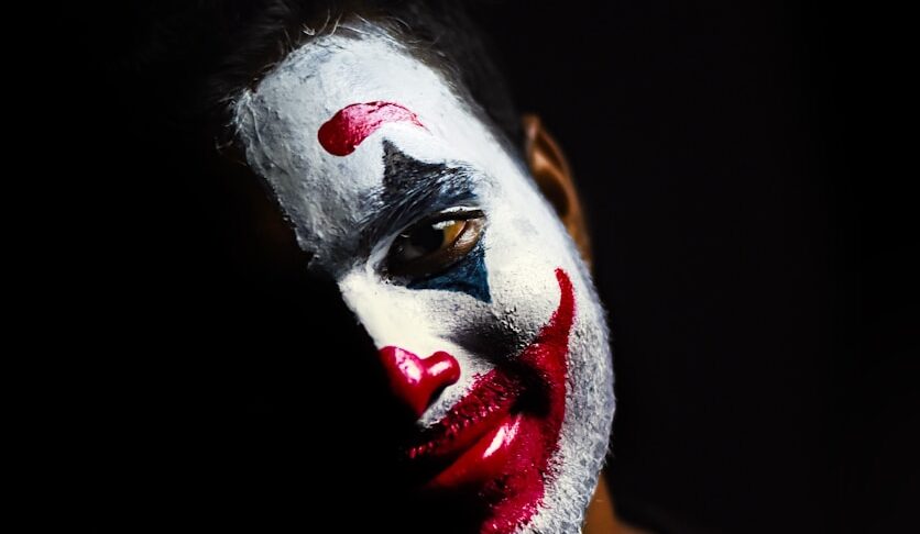 person with red and white face paint