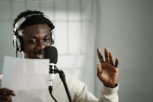 a man wearing headphones and holding a microphone