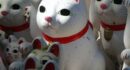 white red and yellow ceramic cat figurines